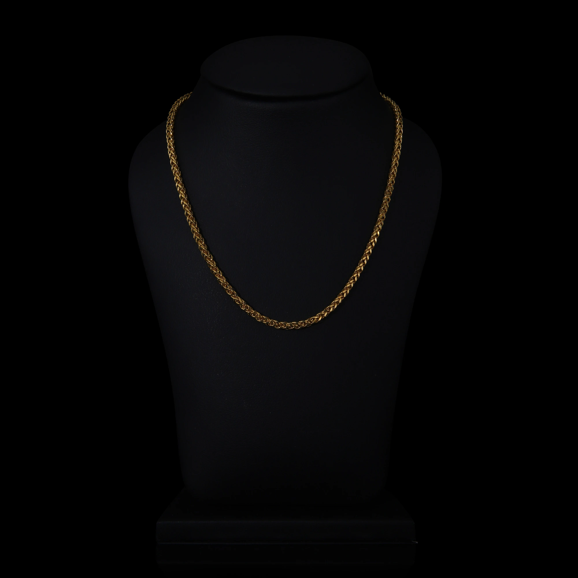 gold chain on black dummy with black background