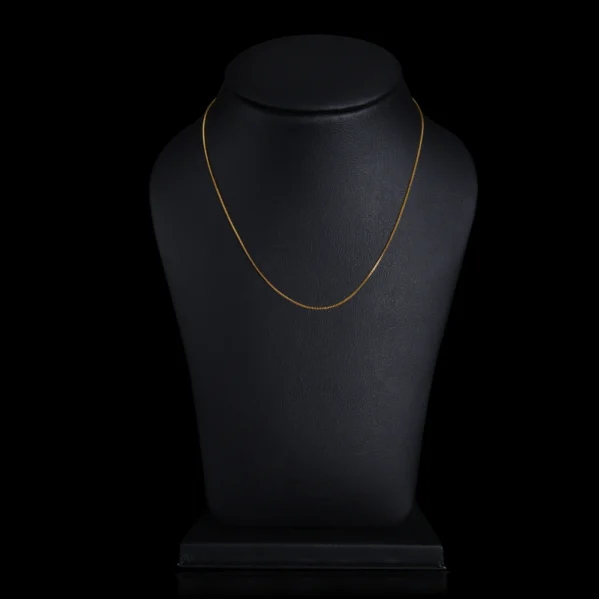 gold chain on black dummy with black background