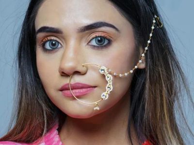A bridal wear kundan nose ring in their nose